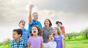 a group of people standing on top of a grass covered field