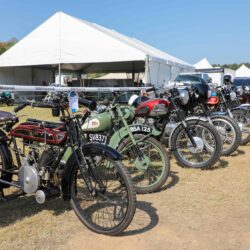 a row of parked motorcycles sitting in a parking lot